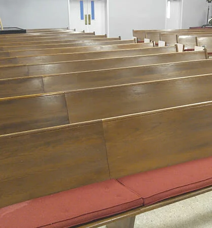 Finished pew cushions in a church sanctuary