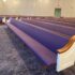 Close Up of Purple Upholstered Church Pews with White Ends