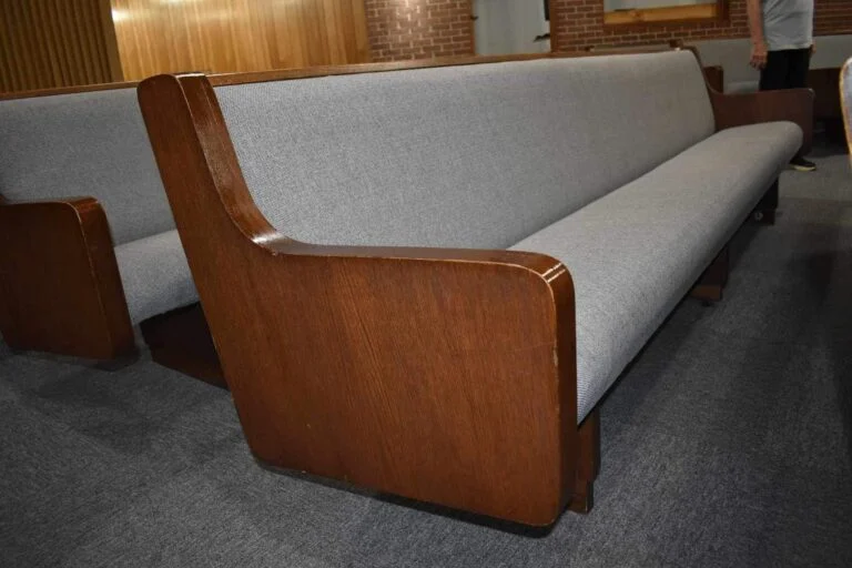 Upholstered pew end beside new carpet tile, Glennville, GA