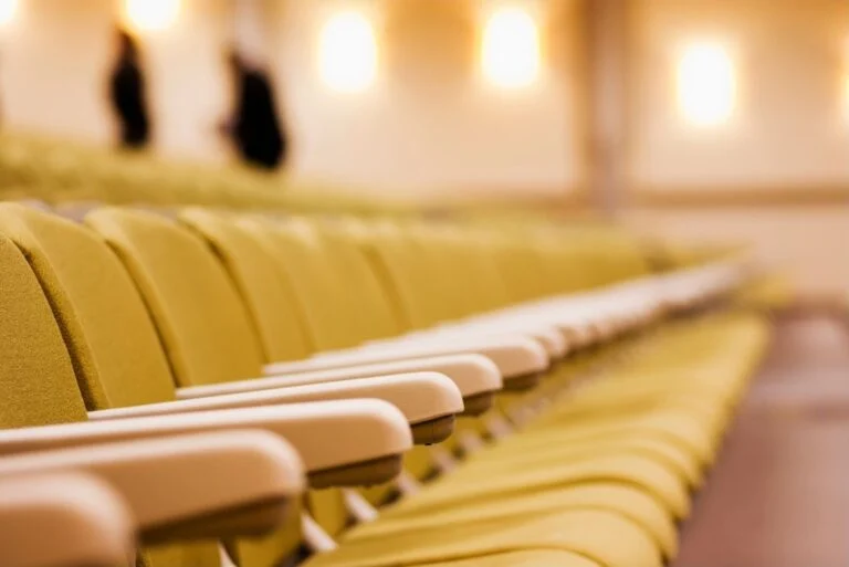 Upholstered theater-style church seats in an auditorium