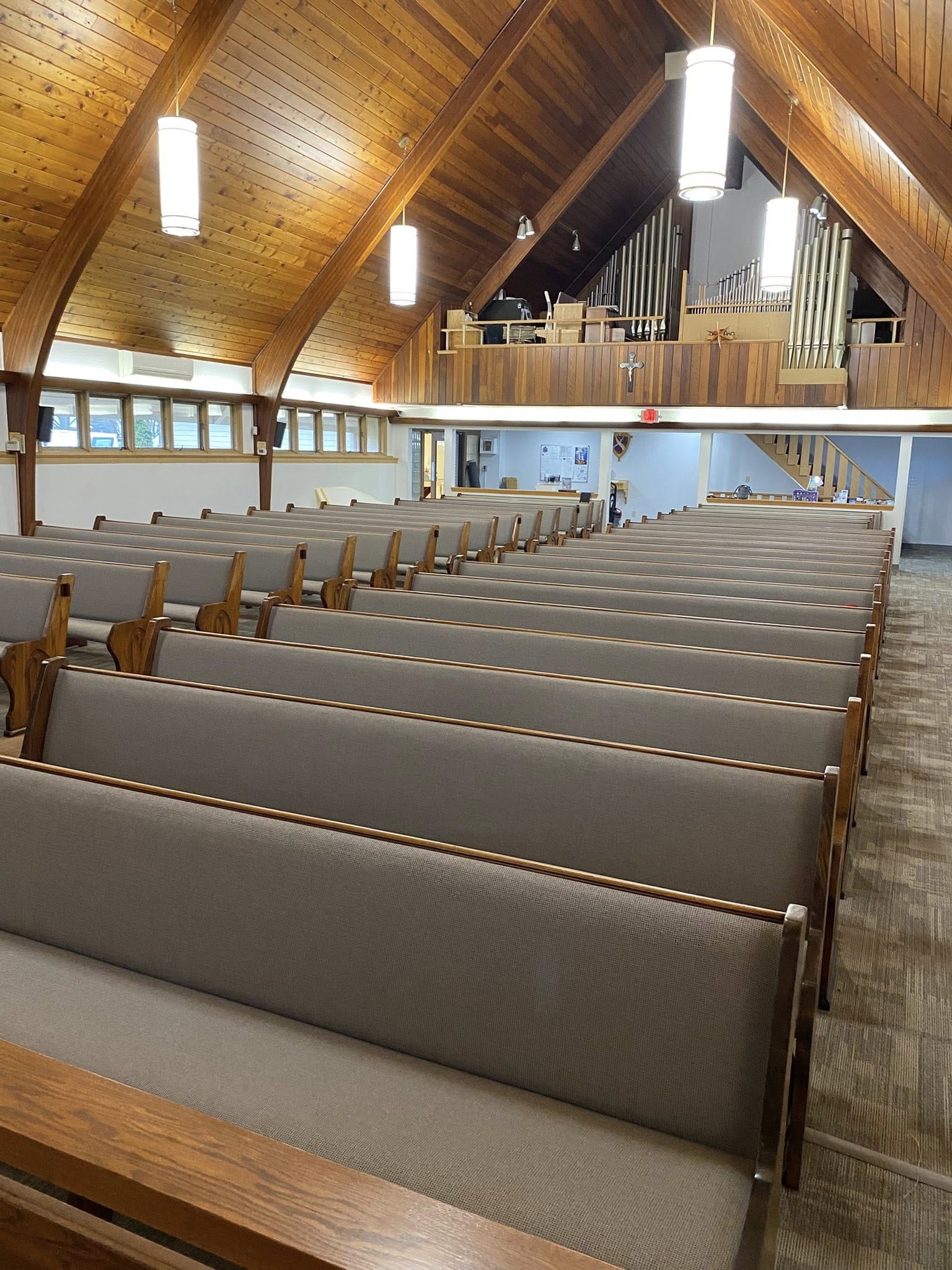 Padded wood pews with new fabric