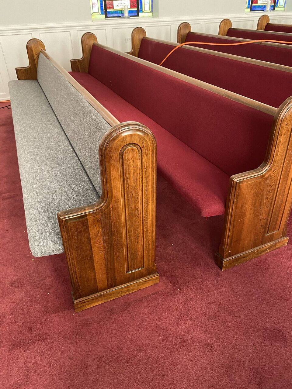 Crew upholstering church pews on-site
