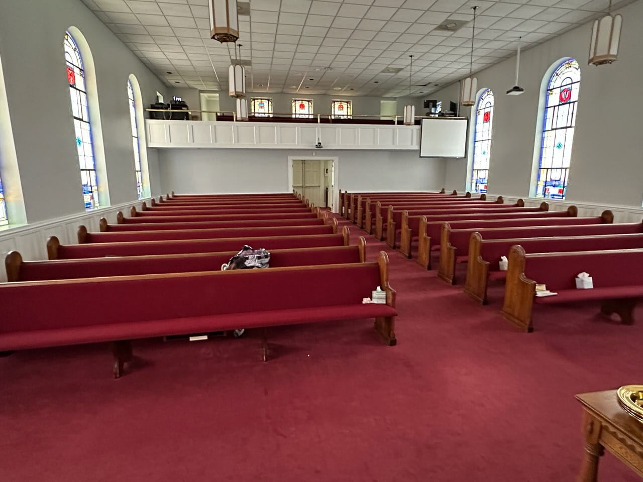 Church pew upholstery before and after: worn burgundy pews before, Cherryville, NC