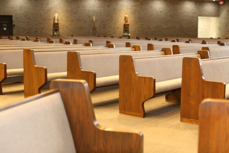 Oak church pews with beige upholstery and matching new carpet, Victoria, TX